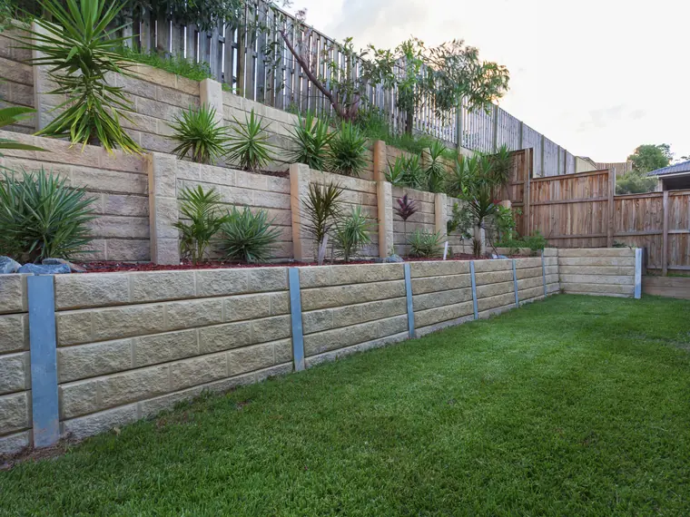 Retaining wall footing preparation - excavation and base material installation before block work begins